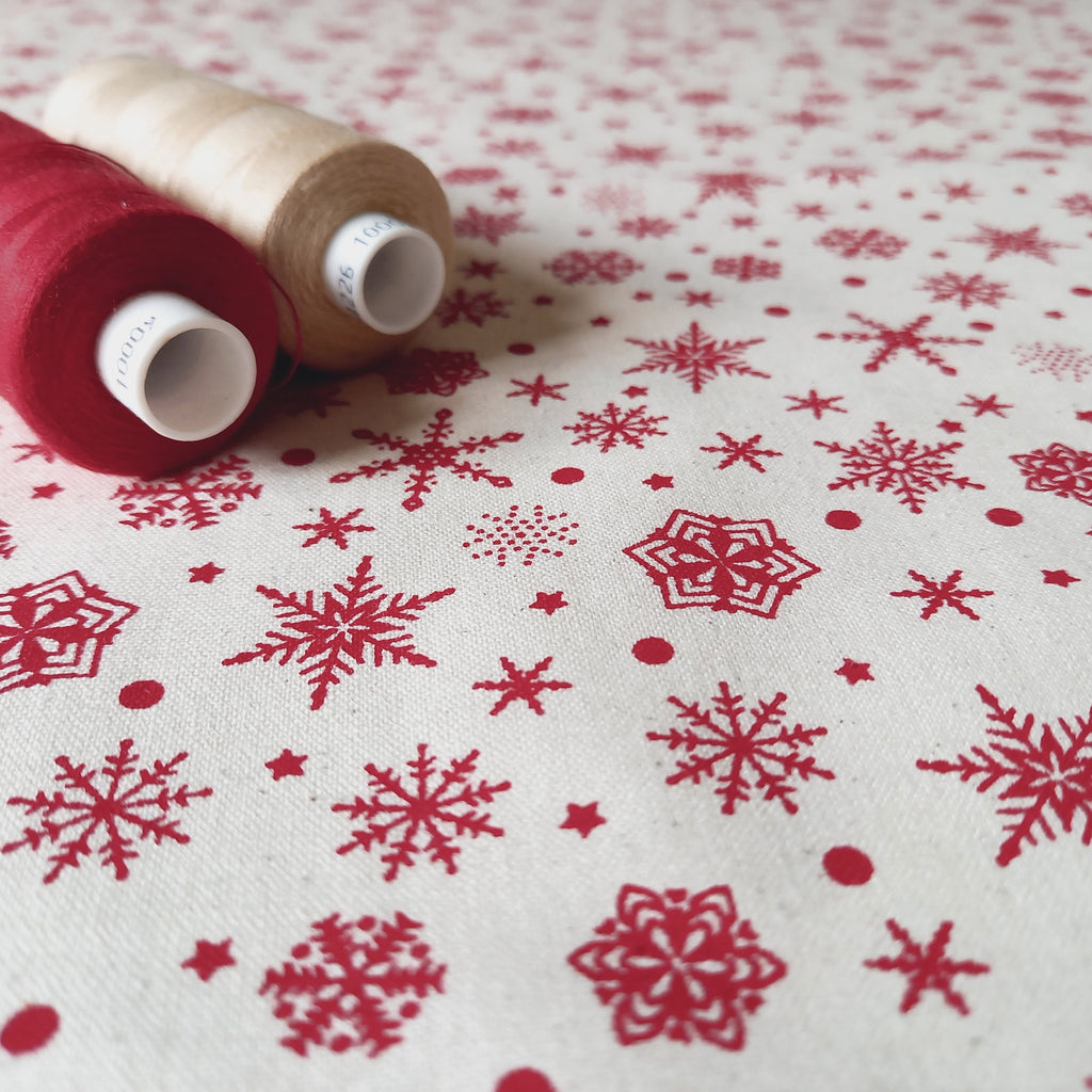 Red Snowflakes on Calico Fabric