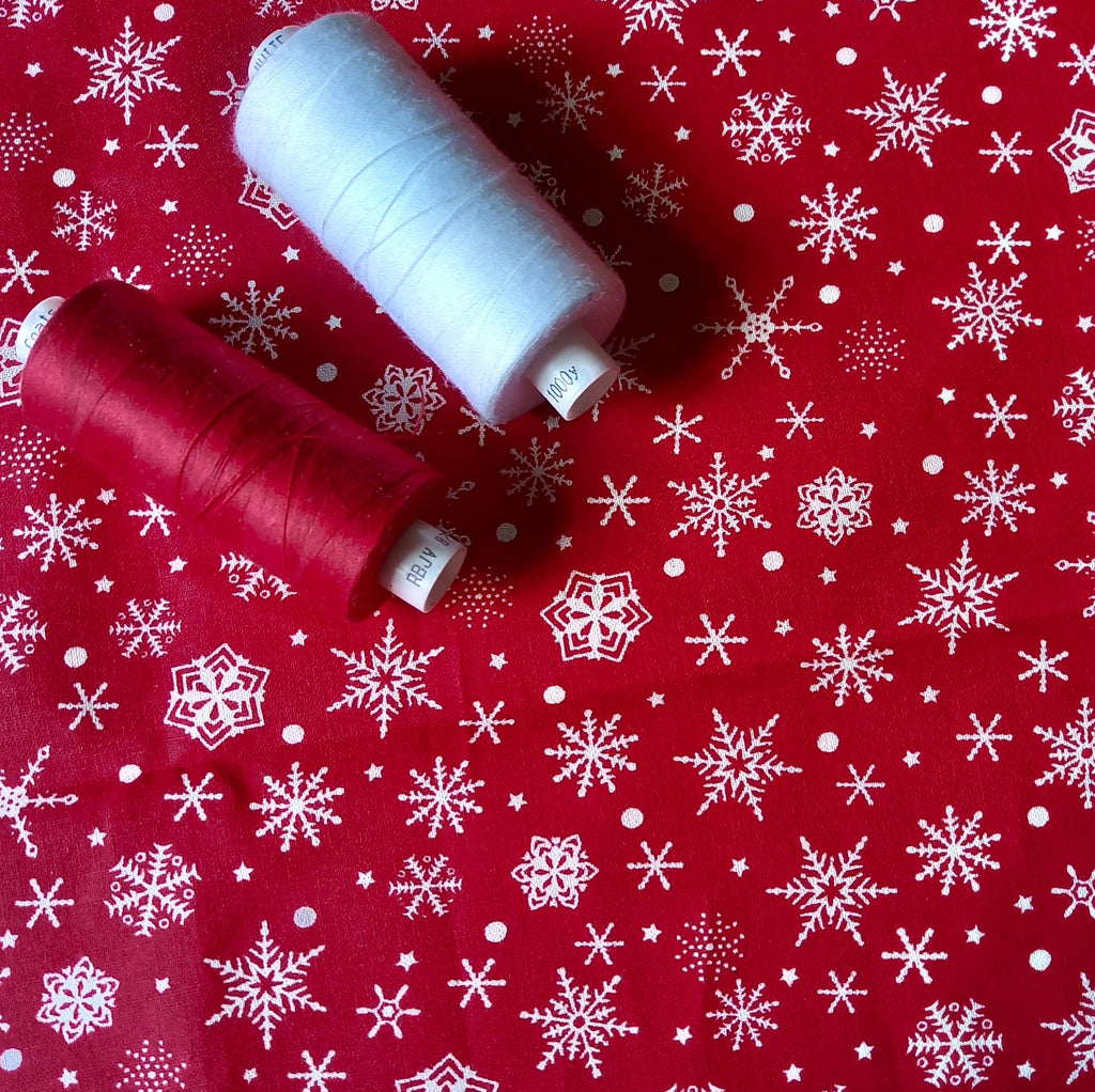 Festive Red Cotton Fabric Scattered with  Cream Snowflakes